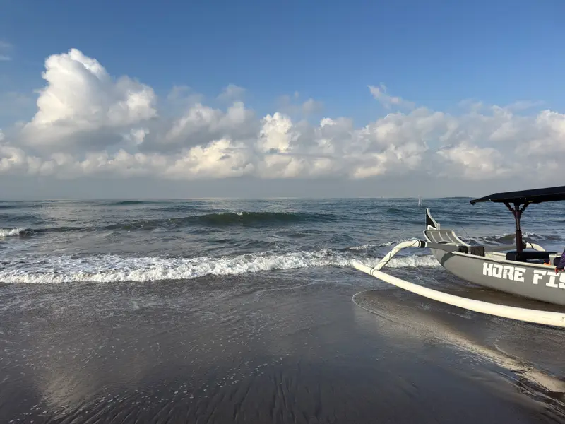 A fishing boat pulled up at the water's edge on Nelayan beach